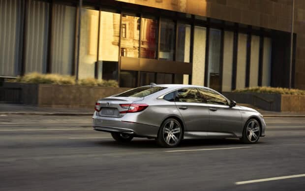A silver Honda Accord drives past modern urban buildings during golden hour, 2K Desktop Wallpaper