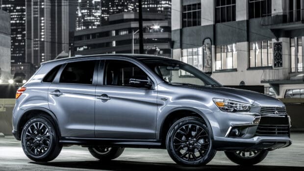 A silver Mitsubishi Outlander parked in a city environment at night, 4K Desktop Wallpaper