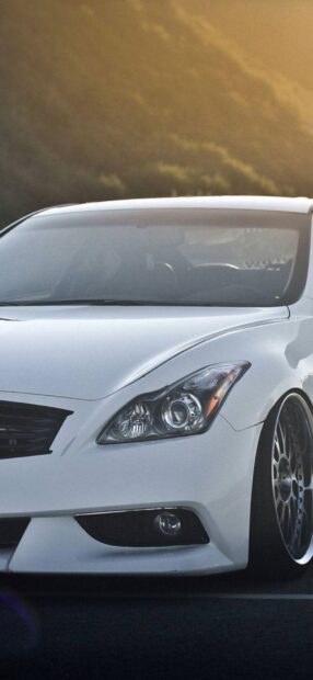 A white Infiniti G37 parked with the sunset sky in the background, HD Phone Wallpaper