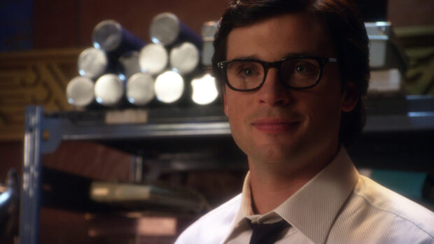 A young man wearing glasses and a white shirt from Smallville Tv Series Wallpapers looks thoughtful, HD Desktop Wallpaper