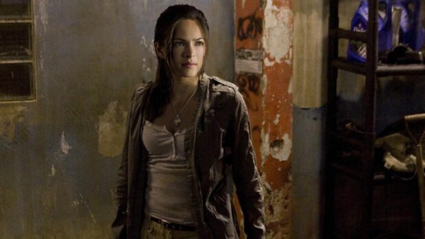 A woman stands in a dimly lit room with worn walls in Smallville Tv Series Wallpapers, HD Desktop Wallpaper