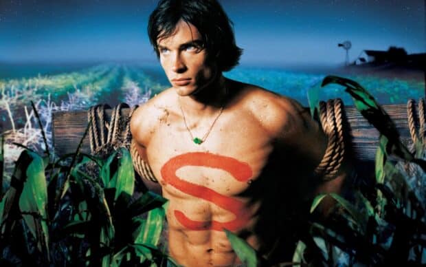 A shirtless man with a red S symbol is tied up in a field, HD Desktop Wallpaper