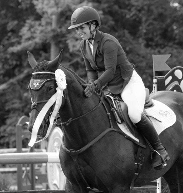 A female equestrian smiles while sitting on a horse after a jumping eventing competition, HD Desktop Wallpaper