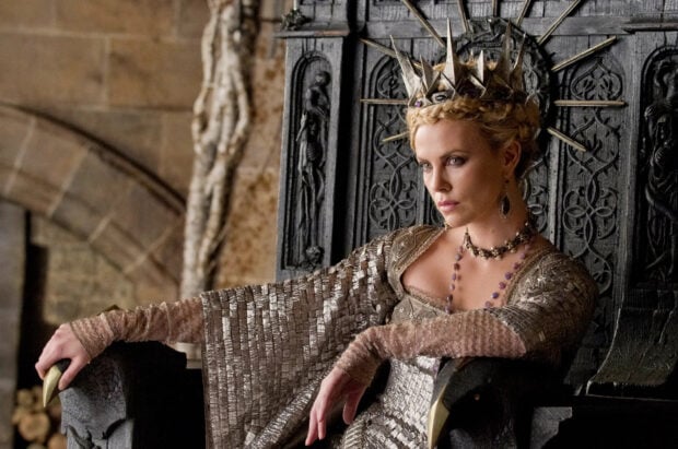 A queen from Snow White And The Huntsman sitting on an ornate throne wearing a jeweled crown, HD Desktop Wallpaper