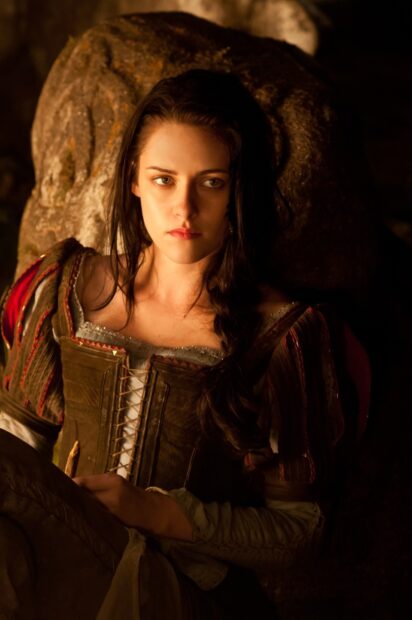 A focused woman from Snow White And The Huntsman wallpapers resting by a stone, HD Phone Wallpaper