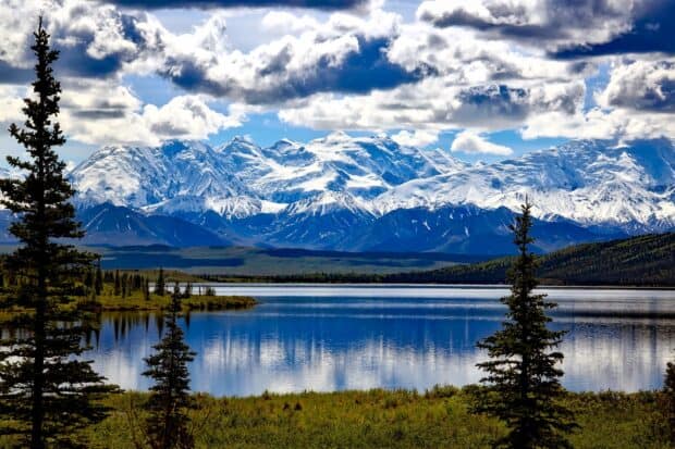 The snow capped peaks reflect beautifully over the calm lake in Denali National Park and Preserve, HD Desktop Wallpaper
