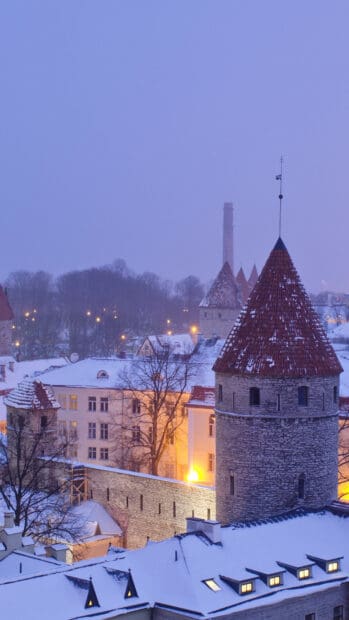 Snow covered medieval towers and buildings in Estonia during winter evening, HD Phone Wallpaper