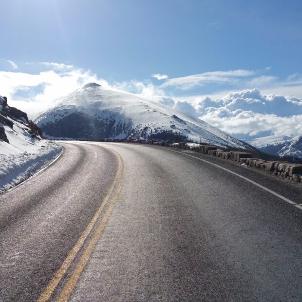 A winding road leads through snowy peaks in Rocky Mountain National Park, HD Desktop Wallpaper