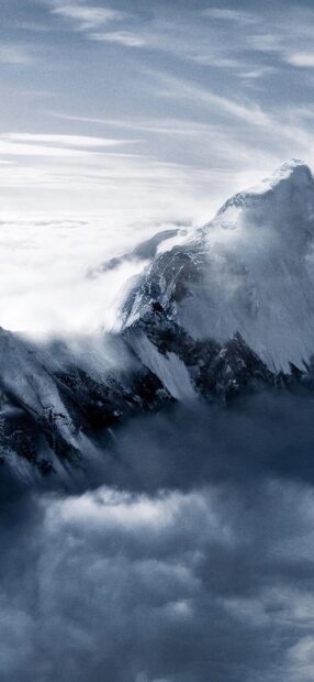 A snow covered mountain peak rises above thick clouds in the Tibetan highlands, HD Phone Wallpaper