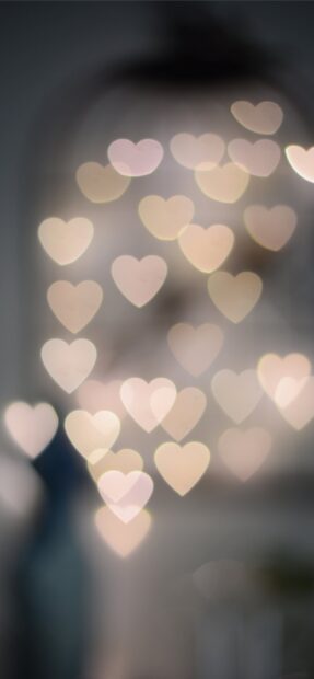 Soft glowing heart shapes in bokeh light creating a romantic blurred effect, 2K Mobile Wallpaper