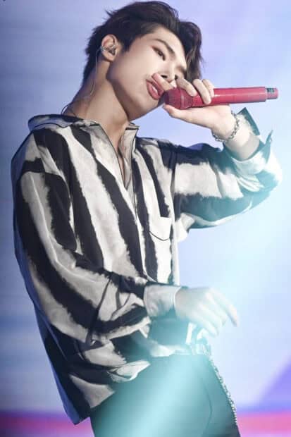 Song Min Gi Ateez holds a red microphone while performing on stage with intense expression, HD Mobile Wallpaper