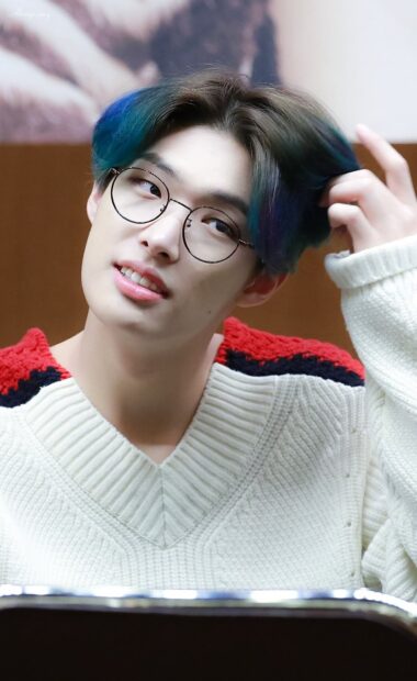 Song Min Gi Ateez smiles gently while adjusting his hair in a cozy sweater, HD Phone Wallpaper