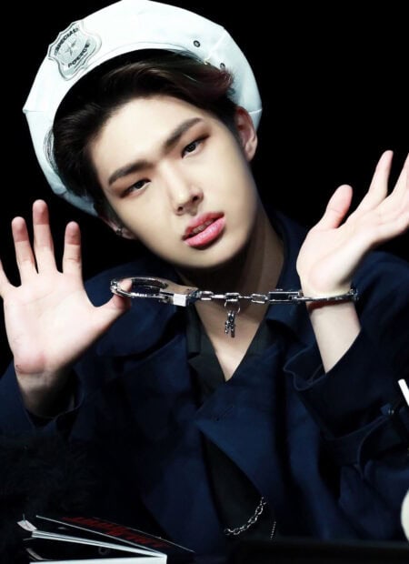 Song Min Gi Ateez wallpapers shows him wearing a navy jacket and white hat with handcuffs between his hands, HD Mobile Wallpaper