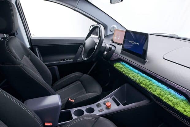 The Sono Motors interior features a unique green decorative element on the dashboard and modern displays, HD Desktop Wallpaper