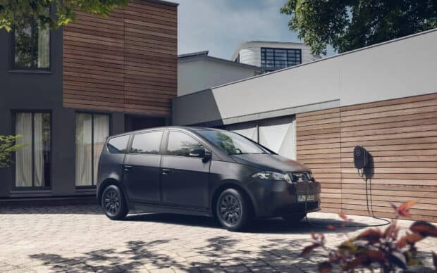A Sono Motors electric van is charging at a home station, HD Desktop Wallpaper