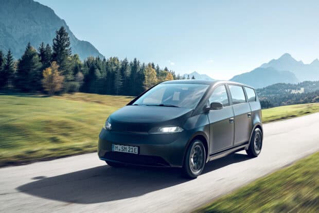 Sono Motors Wallpapers showcasing an electric vehicle driving through a scenic mountainous area, HD Desktop Wallpaper