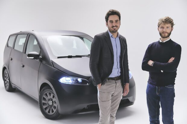 Sono Motors Wallpapers, Two men standing next to a Sono Motors electric car in a studio setting, 2K Desktop Wallpaper