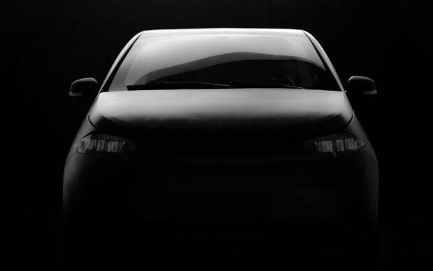 The front view of a Sono Motors electric vehicle is shown in a dark setting, Sono Motors Wallpapers, HD Desktop Wallpaper