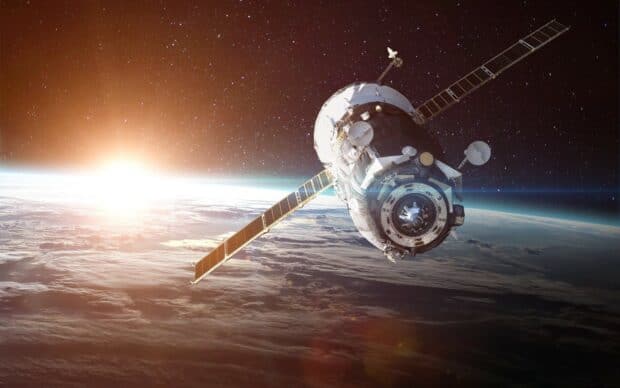 A space station orbits Earth with the sun rising behind it and stars in the background, HD Desktop Wallpaper