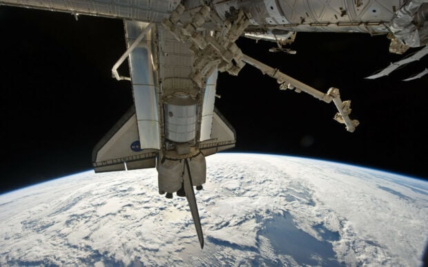 A space station is orbiting the Earth showing the planet’s clouds and surface, HD Desktop Wallpaper