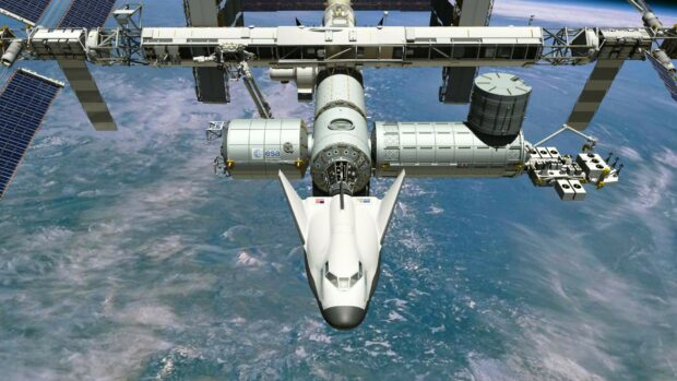 The space station with a shuttle docked is orbiting Earth in space station wallpapers, HD Desktop Wallpaper