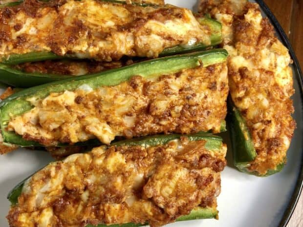 A close up of spicy stuffed jalapeno peppers with cheese filling on a plate, HD Desktop Wallpaper