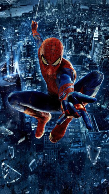 Spider Man Andrew Garfield swinging over a nighttime cityscape with glass shards, 4K Phone Wallpaper
