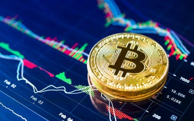 A stack of bitcoin coins lies on a digital financial chart showing trends, HD Desktop Wallpaper
