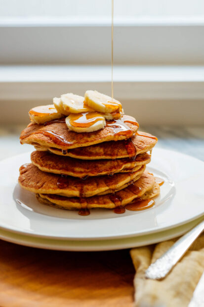 A stack of pancakes topped with banana slices and syrup dripping down, HD Phone Wallpaper