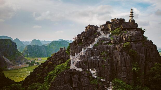 A stone staircase leads to the ancient pagoda on a rocky mountain surrounded by greenery in Vietnam Wallpapers, HD Desktop Wallpaper