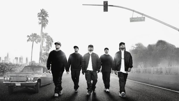 The group from Straight Outta Compton walking under a streetlight with cars and palm trees around, HD Desktop Wallpaper