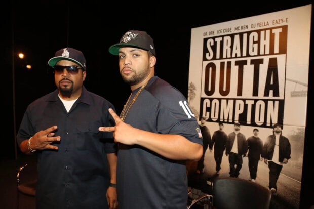 Two men pose in front of a Straight Outta Compton poster showing hip hop culture, 2K Desktop Wallpaper