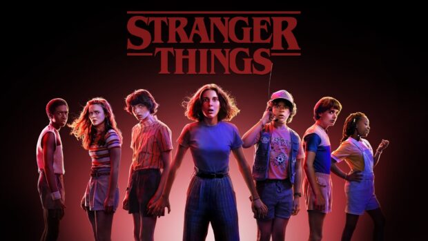 Gaten Matarazzo and friends stand under red light from Stranger Things, HD Desktop Wallpaper