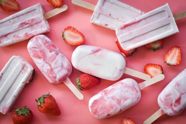 Strawberry popsicles with fresh strawberries on a pink surface, HD Desktop Wallpaper