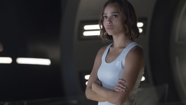 A confident woman stands with arms crossed in a futuristic environment featuring soft lighting, Allegiant Wallpapers, 4K Desktop Wallpaper