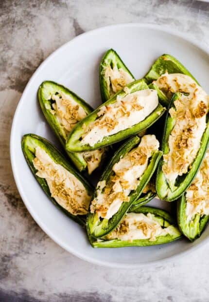 A close up of jalapeno peppers filled with creamy cheese and topped with seasoning, HD Mobile Wallpaper