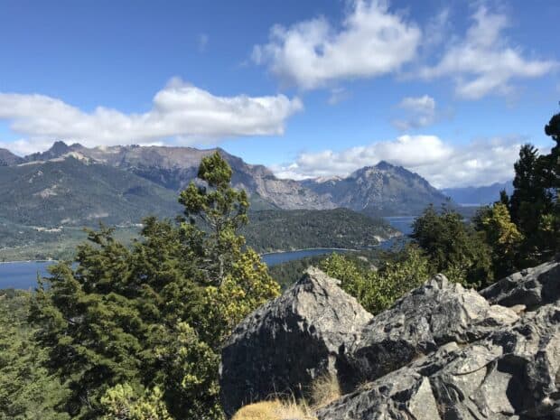 A scenic view of Nahuel Huapi with mountains, trees, and a lake under a bright sky, HD Desktop Wallpaper