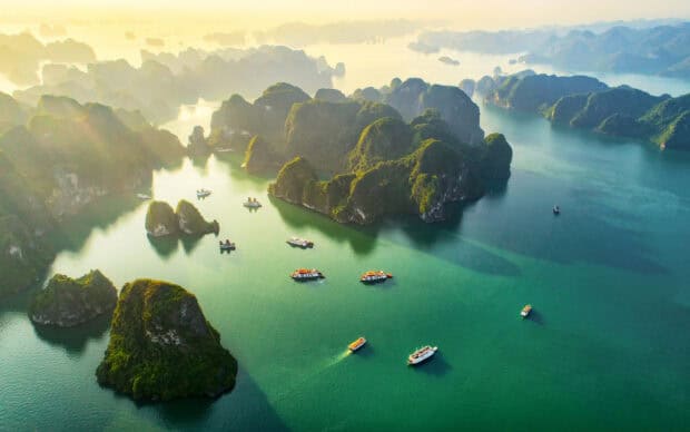 Aerial view of boats sailing through limestone islands in Vietnam waters, HD Desktop Wallpaper