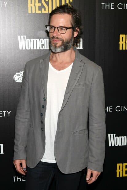Guy Pearce is wearing a gray blazer and glasses at a red carpet, 2K Desktop Wallpaper