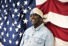 Lil Yachty is wearing a denim jacket and headwear standing in front of the US flag, 2K Desktop Wallpaper