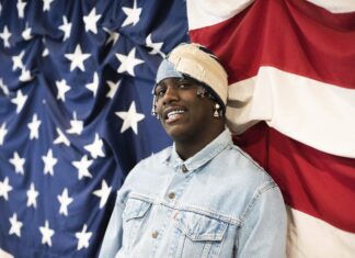 Lil Yachty is wearing a denim jacket and headwear standing in front of the US flag, 2K Desktop Wallpaper