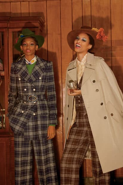 Two women wearing plaid suits and hats in a stylish Marc Jacobs setting, 2K Desktop Wallpaper