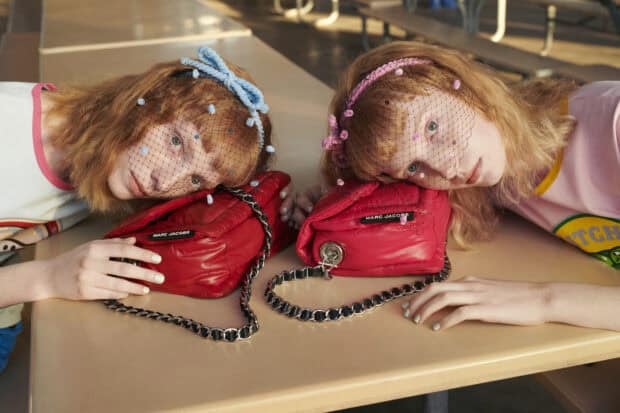 Two models rest their heads near stylish Marc Jacobs bags with chain straps, HD Desktop Wallpaper