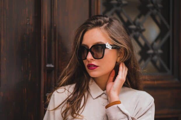 A young woman wearing Marc Jacobs sunglasses with floral details poses in front of a wooden door, HD Desktop Wallpaper