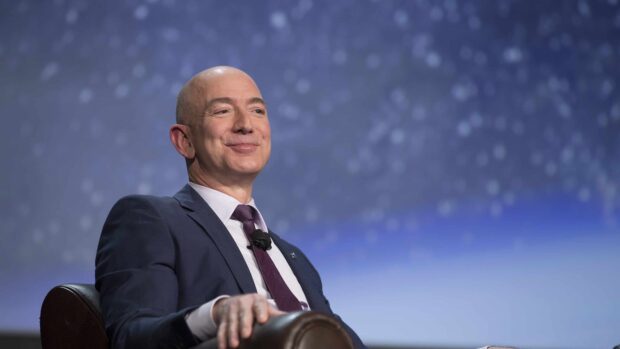 The successful Amazon Wallpapers founder is sitting on a chair with a blurred starry background, 4K Desktop Wallpaper