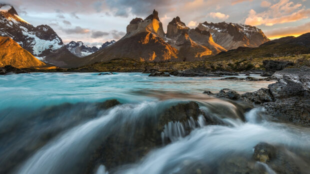 A cascading river flows through rocky terrain at Torres Del Paine National Park, HD Desktop Wallpaper