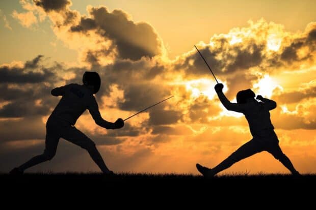 Two fencers engage in a duel during sunset with dramatic clouds in the background, HD Desktop Wallpaper