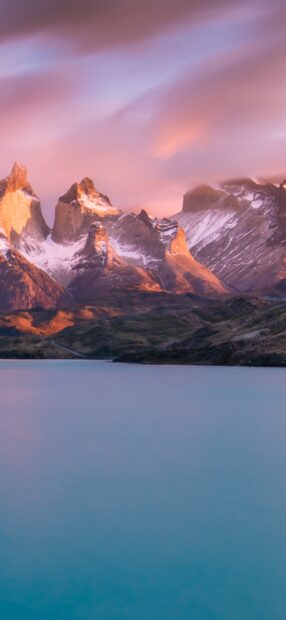 The Torres Del Paine National Park mountains glow warmly under a colorful sunset sky, HD Mobile Wallpaper