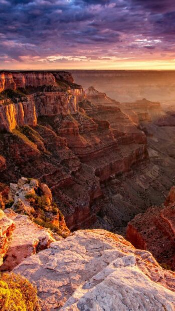 The Grand Canyon cliffs glow warmly under a colorful sunset sky, HD Phone Wallpaper