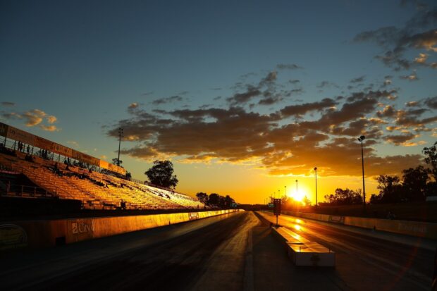 The race track shows the setting sun with clouds and empty stands, HD Desktop Wallpaper